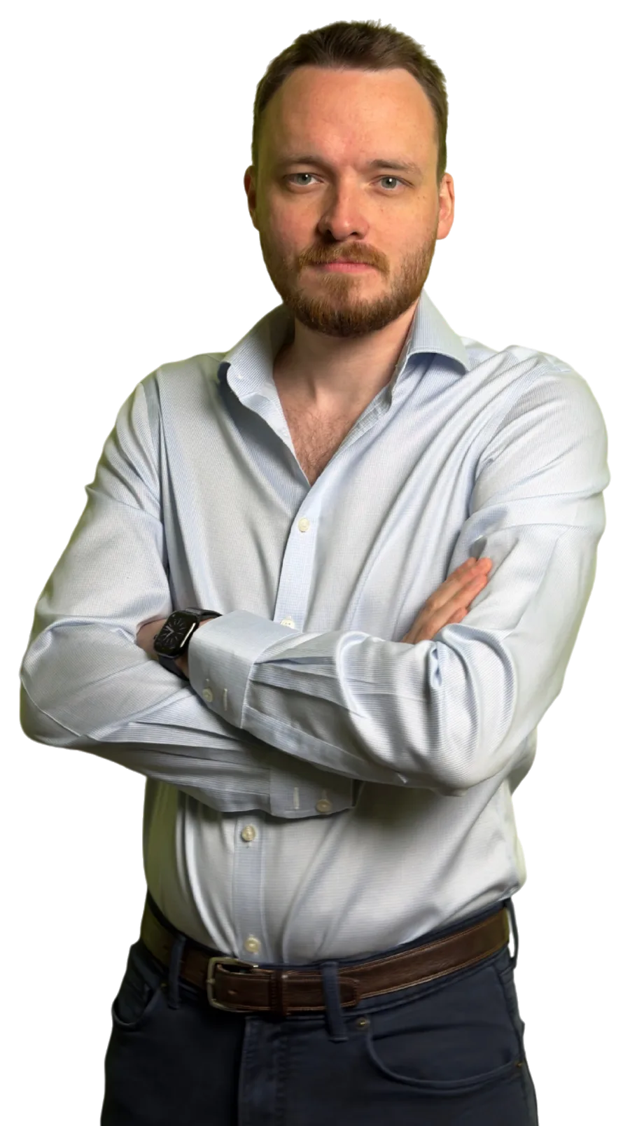 Anthony in a pale blue shirt with his arms folded