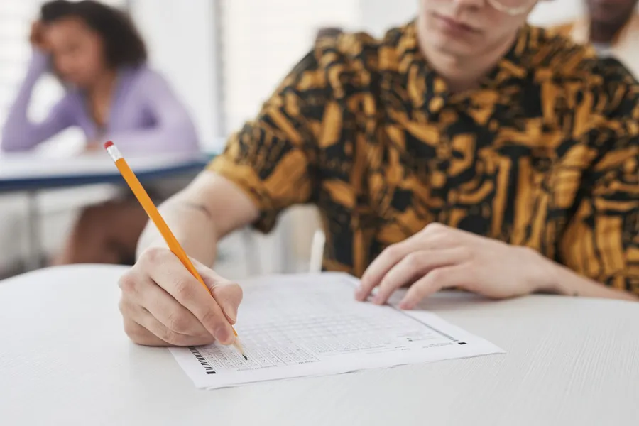 A pencil filling in an exam answer sheet