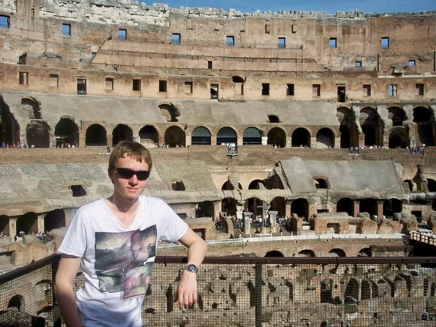 A younger Anthony in sunglasses inside the Colosseum in Rome