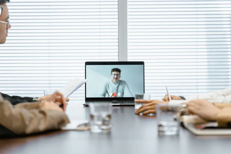 A team on a video call with a remote colleague
