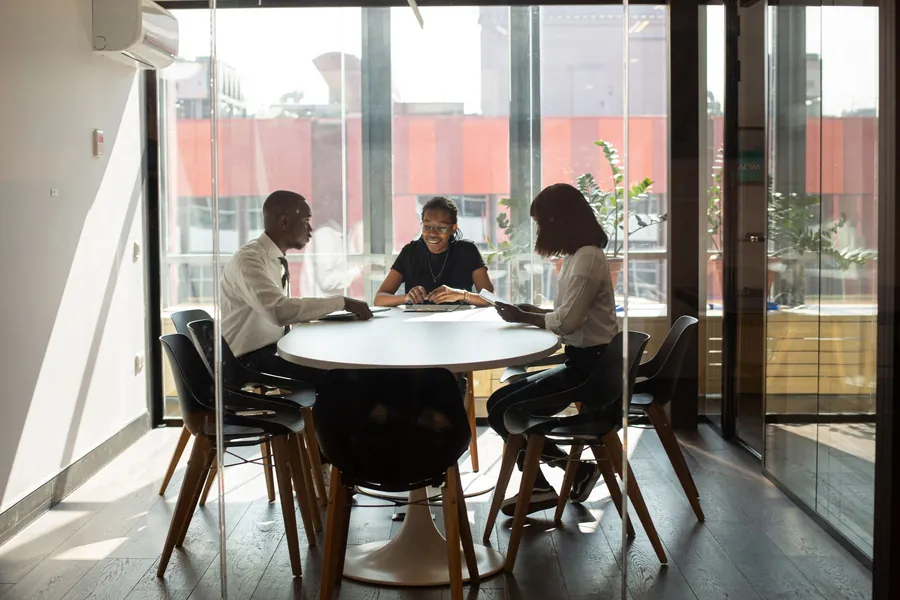 Colleagues around a table in a team meeting